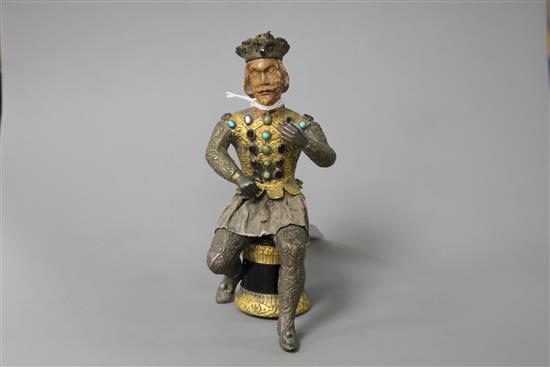 An Austro-Hungarian gilt and white metal figure of a seated knight, with jewelled decoration and hardwood head, height 11.5cm